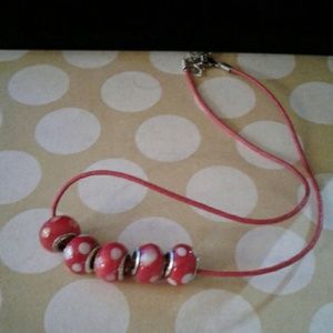 5 red and white dots euro beads on a red cord